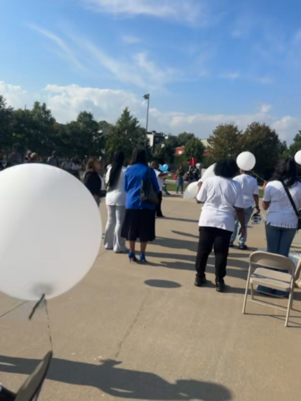 White balloons held among attendees at the remembrance gathering